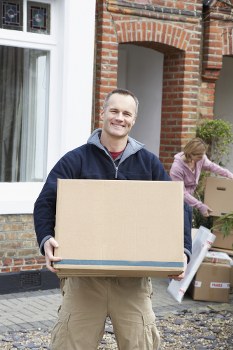 Removal van and moving boxes in Downham residential street