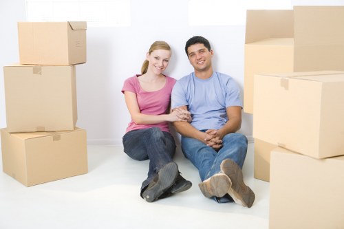 Removal team handling furniture during a house move in Downham