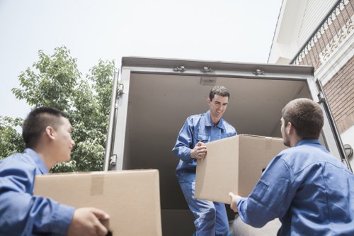 Packed boxes and moving supplies prepared for a Downham removals job
